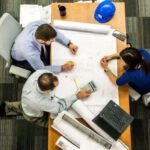 Risk Management - Three People Sitting Beside Table