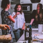 Social Return - Men and Women Standing Infront of Dining Table