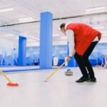 Team Dynamics - Team playing curling on ice sheet