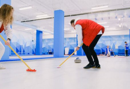 Team Dynamics - Team playing curling on ice sheet