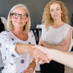 Cross-Sector Partnerships - A Woman Shaking Hands with another Person