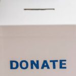 Peer-to-Peer Fundraising - Crop anonymous person showing donation box