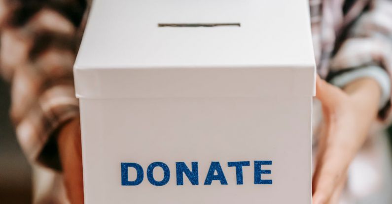 Peer-to-Peer Fundraising - Crop anonymous person showing donation box