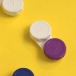 Philanthropy Cases - Colourful lens containers on a yellow background